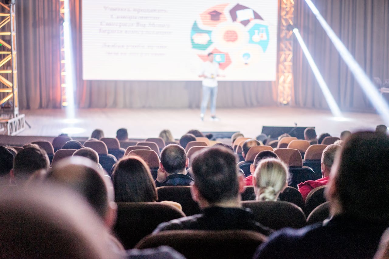 Audience watching a presentation in a conference setting